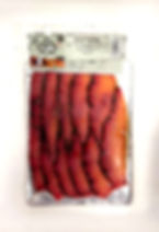 Vacuum-sealed smoked salmon gravadlax infused with beetroot, ready to eat