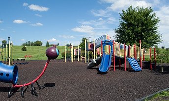 Play structure for younger children with low slides and a caterpillar tunnel