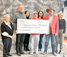 Chamber members presenting a giant check for $515,000 to the City, County and Parks & Recreation department representatives
