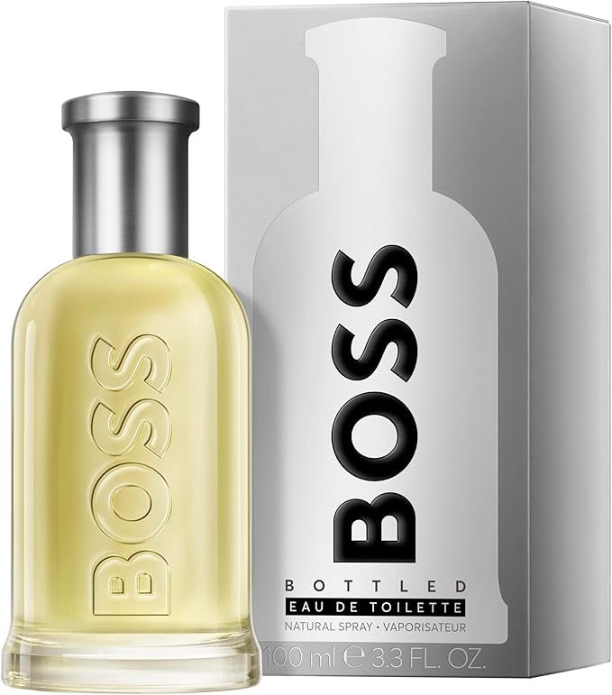 Frasco de perfume BOSS dourado ao lado da caixa cinza, com texto Eau de Toilette e 100 ml.