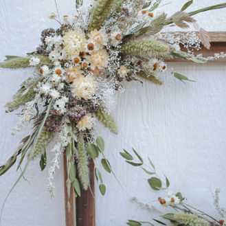 Dried floral arrangement on frame