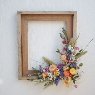 Dried flower arrangement in rustic frame