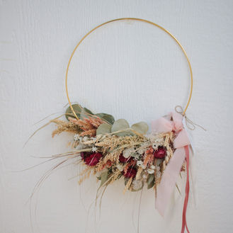 Dried flower wreath with pink ribbon