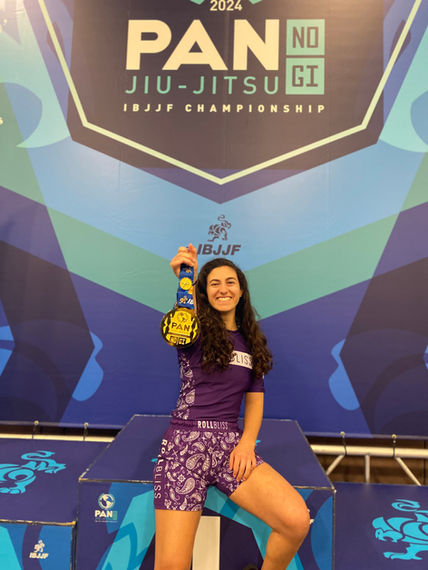 Female Jiu-Jitsu athlete smiles with PAN NO GI JIU-JITSU Championship medal
