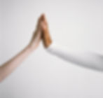 Two hands coming together as a high-five gesture