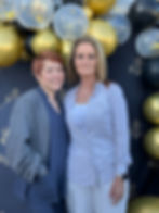 Two women posing with balloons