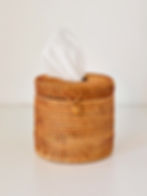 Round natural rattan tissue box with tissue pulled out — bathroom accessory Dubai