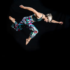dancer in air against black background
