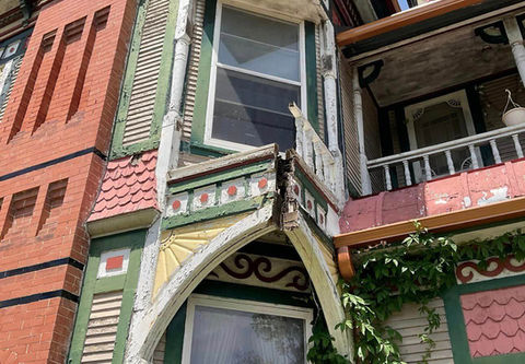 Close-up of turret roof detail on Victorian home – Detailed shot of the turret roof showing worn shingles and intricate woodwork, highlighting the Victorian architectural style before restoration.