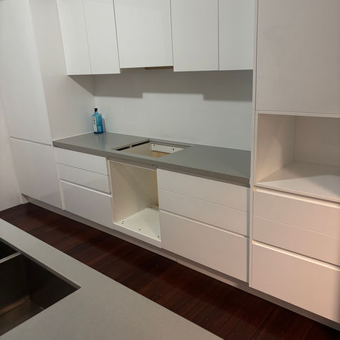 White gloss flat-pack kitchen drawer cabinets in Kora Kitchens Ascot display kitchen