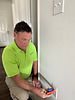 Inspector testing electrical outlet in new construction home