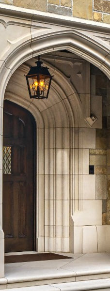 Luxury natural stone entry portal. Elegant arched natural limestone front entrance on a custom luxury residence.