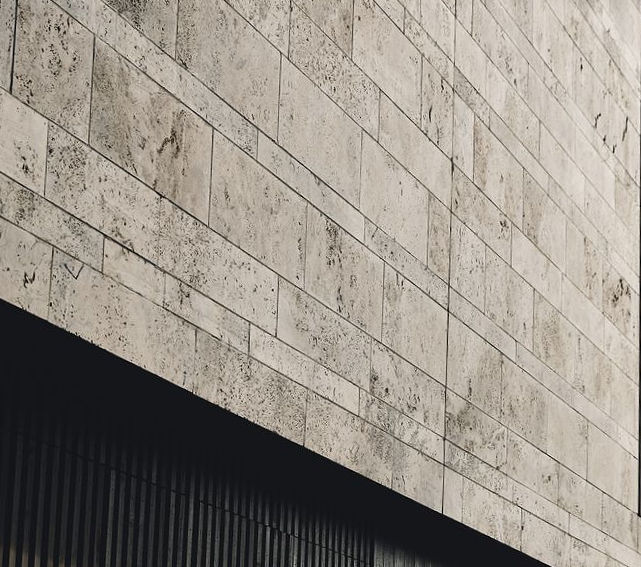 Explore Titanium Travertine, a material offering a high-contrast blend of deep charcoals and silver veins for modern architectural applications.