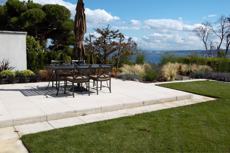 Large-format Tuscan Granite pavers with a honed finish create a clean outdoor dining area at the Magnolia Residence.