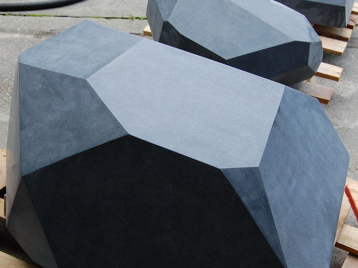 Large-scale landscape sculpture crafted from Imperial Black Granite, serving as both a focal point and functional outdoor seating.