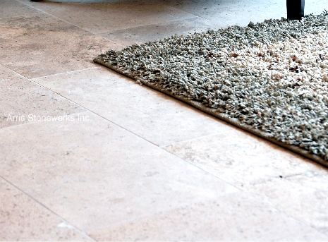 Close-up of large-format Rattan Limestone floor tiles showcasing beige and tan sediment patterns.