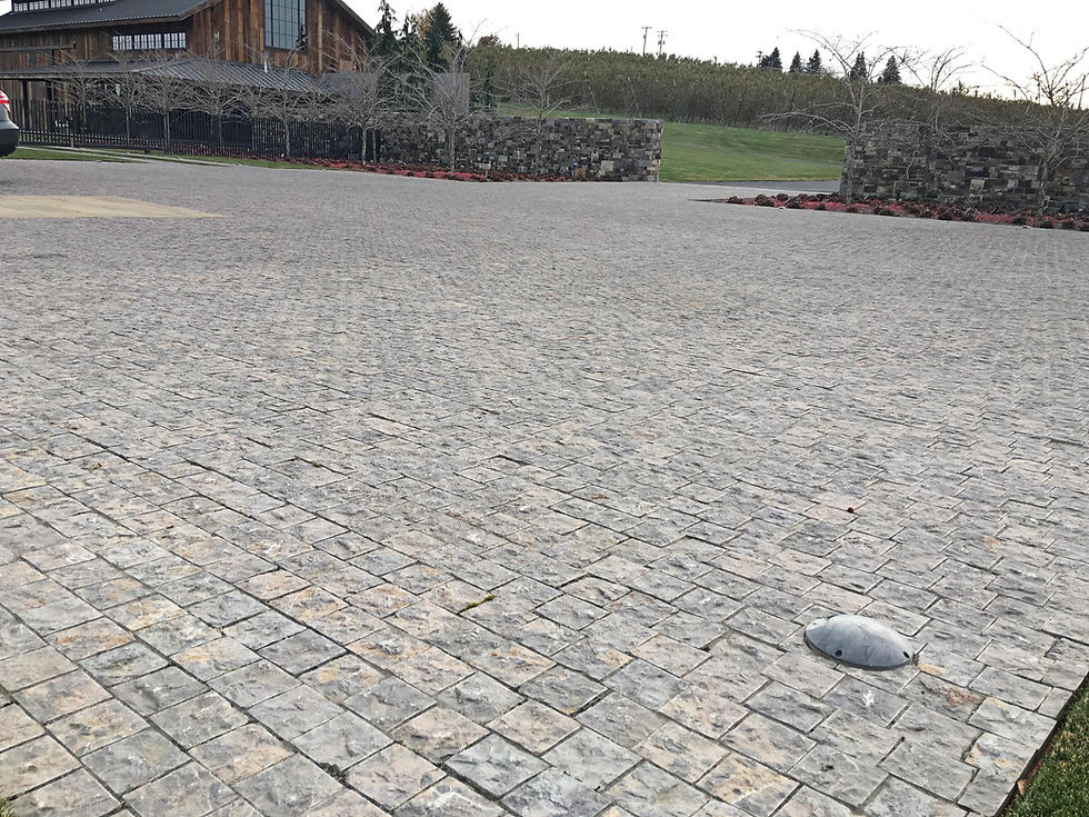 Custom Montipora Limestone parking area with a Tumbled Finish and rich brown tones at the Eastern Washington Residence by Arris Stoneworks Inc.