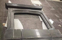 Black wood grain limestone fireplace surrounding