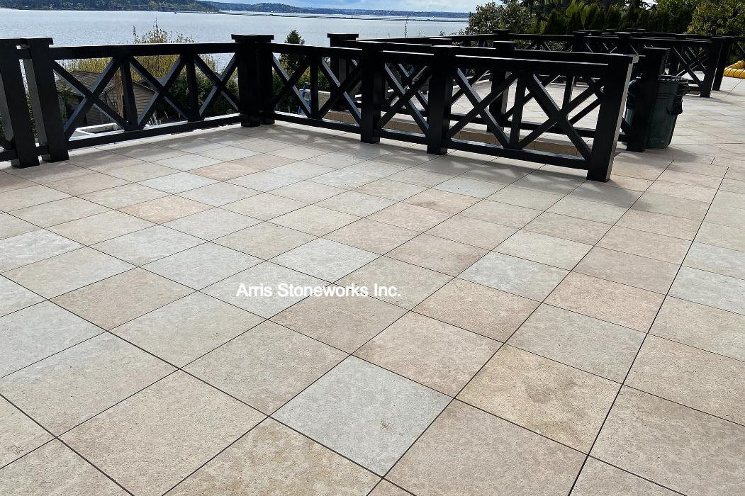 Modern infinity pool deck featuring Coffee Limestone pavers and matching pool coping with an acid wash finish.