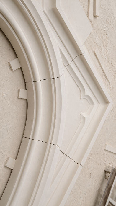 Close-up of smooth, honed Lueders Limestone radial cladding panels featuring crisp geometric joint lines on a modern exterior.
