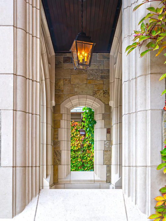 Bespoke deeply recessed architectural entry arch custom-fabricated from honed Lueders Limestone.
