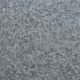 Flamed Obsidian Basalt offering a rugged, high-friction exterior texture that maintains a consistent charcoal-black palette for safe outdoor walkways and patios.