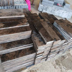 Production stack of Montipora Limestone wall cladding panels, highlighting the material's varied textural finishes and uniform calibration for easy installation