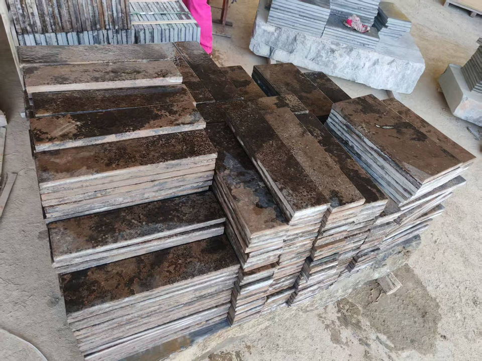 Production stack of Montipora Limestone wall cladding panels, highlighting the material's varied textural finishes and uniform calibration for easy installation