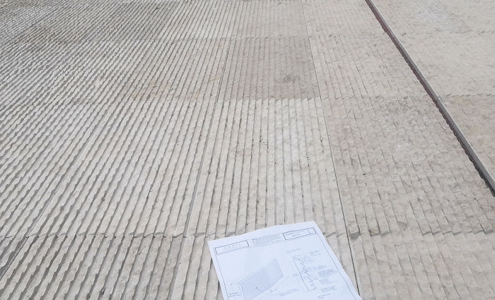Large-scale dry-lay of Khaki Limestone floor tiles with architectural shop drawings, ensuring precise pattern alignment and natural fossil distribution.