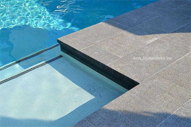 coffee limestone, brown limestone, limestone pool coping, limestone paving, brown limestone, fine adze finish, limestone water feature, limestone paving, stone water drain