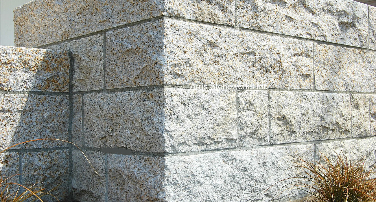 Waterfront residence featuring structural retaining walls and built-in seating made of Tuscan Granite with a natural Split finish.