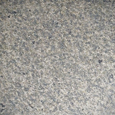 Honed Pepper Corn Granite surface showcasing a smooth matte finish that reveals the stone's deep brown tones and complex black crystalline texture.