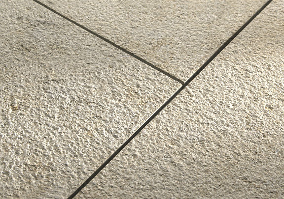 Close-up of a Khaki Limestone panel with a high-texture, slip-resistant lychee surface finish showing parallel masonry joints.
