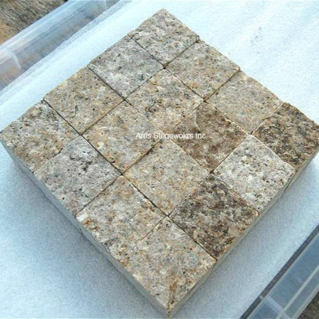 Detail shot of custom-cut Antique Granite square tiles provided by Arris Stoneworks for a luxury spa interior.
