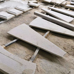 Stacked radial Tuscan Granite stair treads in the workshop, showing the uniform color profile and precision cutting for grand exterior staircases.