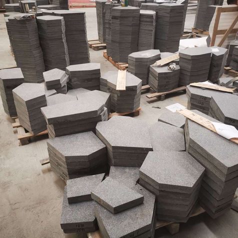 Inventory of thick-cut Black Galaxy Granite dimensional blocks, demonstrating the material's suitability for heavy-duty commercial bollards and structural landscape features.