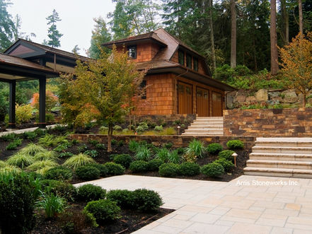 Custom-fabricated Sorrel Granite patio pavers with a slip-resistant Lychee and Split finish for a Northwest coastal home.