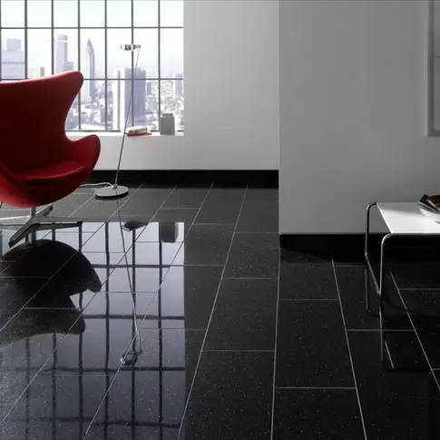 Luxury office lobby featuring polished Black Galaxy Granite flooring, showcasing the deep black background and reflective metallic flecking that creates a sophisticated, high-contrast interior aesthetic.