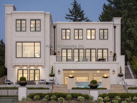 Modern residential facade with honed Eggshell White Limestone wall veneers and precision-carved door surrounds in Seattle.