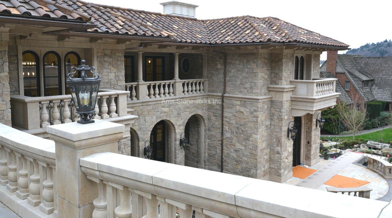 Front entry featuring majestic structural limestone columns and custom-fabricated stone plinths.