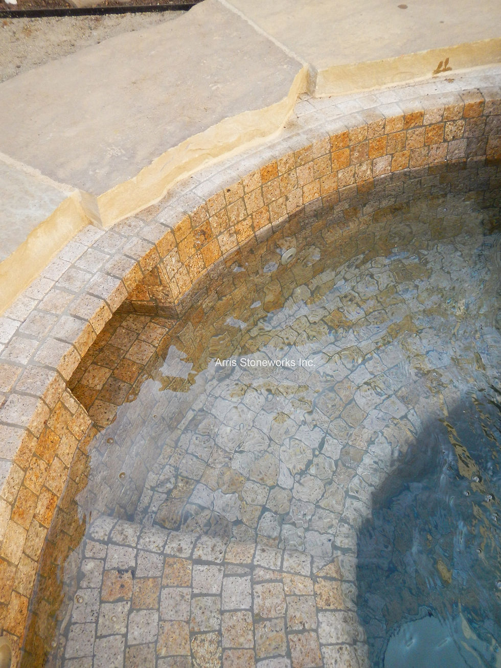 Detail shot of custom-cut Antique Granite square tiles provided by Arris Stoneworks for a luxury spa interior.