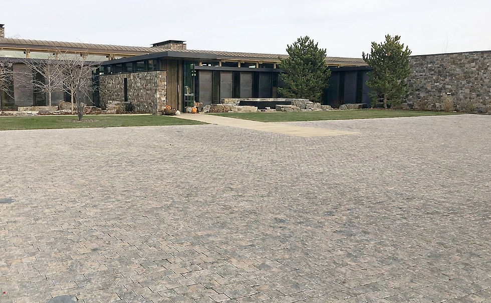 Custom Montipora Limestone parking area with a Tumbled Finish and rich brown tones at the Eastern Washington Residence by Arris Stoneworks Inc.