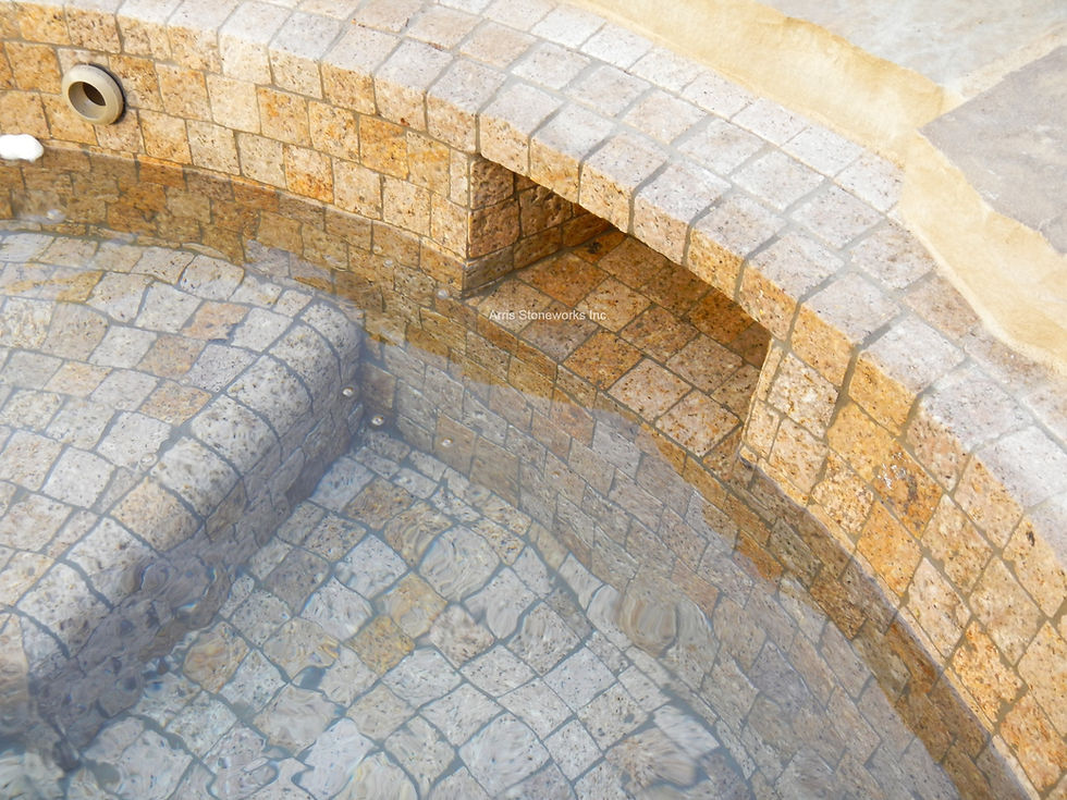 Detail shot of custom-cut Antique Granite square tiles provided by Arris Stoneworks for a luxury spa interior.