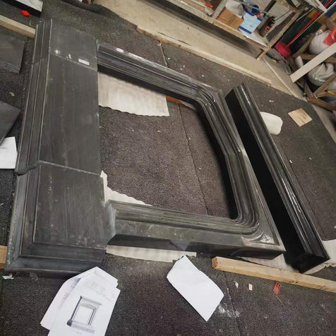 Large-scale architectural frame fabricated from Black Wood Vein Limestone, featuring precision mitered corners that highlight the stone's continuous linear veining.