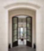 Custom-fabricated curved stone entryway in Eggshell White limestone.