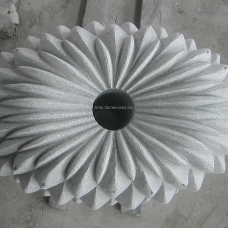 Overhead view of a circular Sea Green Granite element with a radial fin pattern, highlighting precision shop drawings and technical carving.