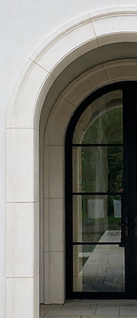 Custom limestone profiles in eggshell white limestone for cured door entry
