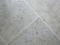 Four square panels of smooth matte honed Light Taupe Limestone tile arranged in a grid layout