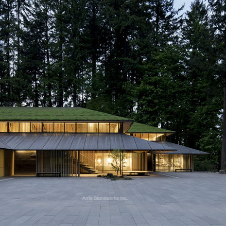 Wide view of the Obsidian Basalt stone courtyard and Cultural Village buildings at the Portland Japanese Garden.