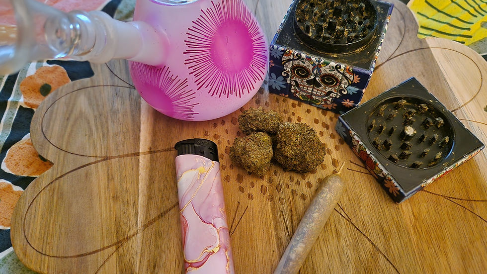 Cannabis, joint, bong, grinder and a lighter, on a wooden flower board